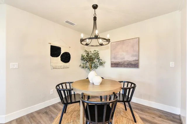 a view of a dining room with furniture wooden floor and chandelier