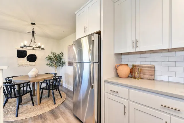 a kitchen with a table stainless steel appliances and cabinets