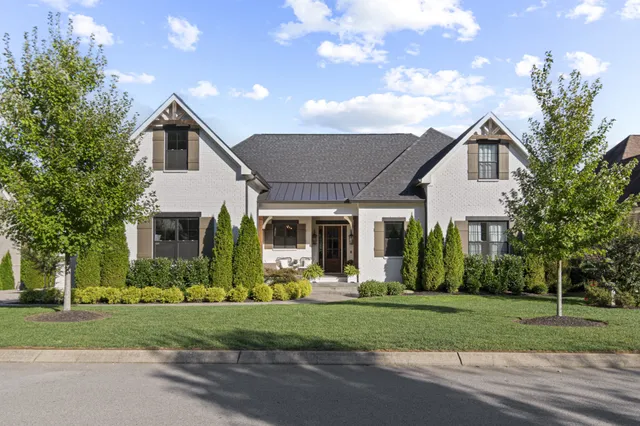 a front view of house with yard and green space