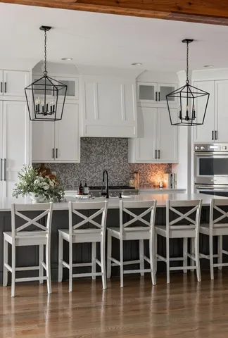 a kitchen with a dining table chairs sink and stove