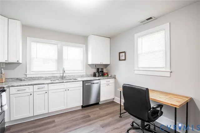a kitchen with sink cabinets and chair