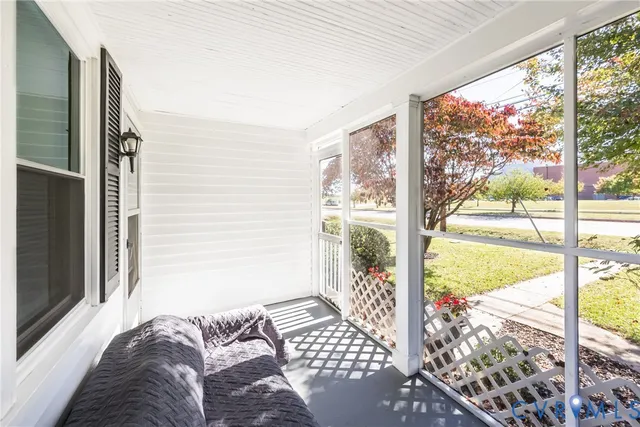 a bedroom with a large window and a bed