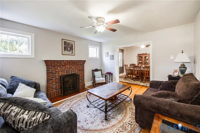 a living room with furniture a fireplace and a window