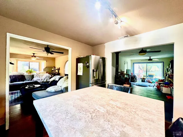 a large bedroom with wooden floor and furniture