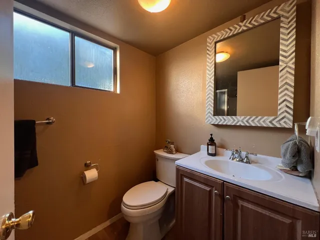 a bathroom with a sink toilet and mirror