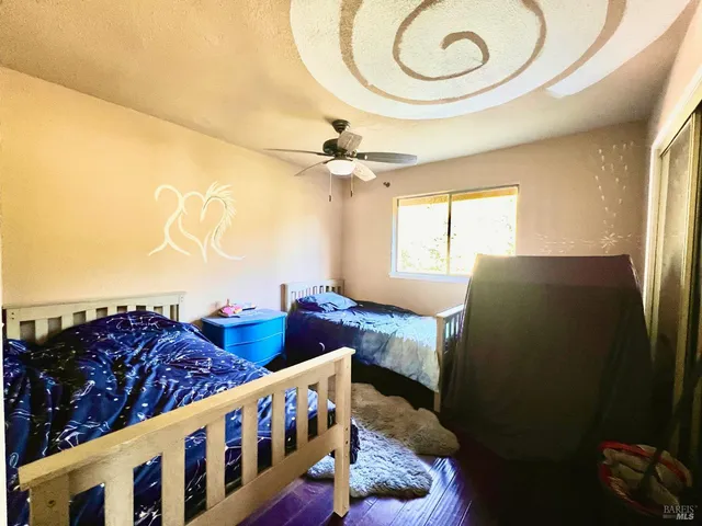 a bedroom with bed and a chandelier
