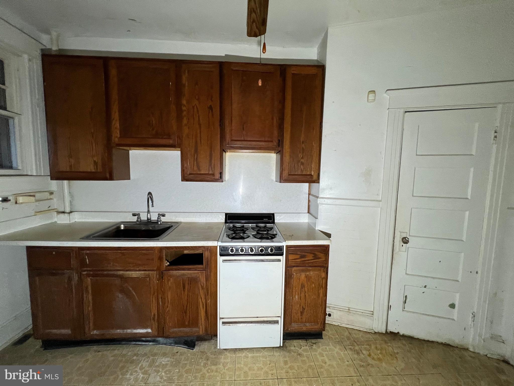 3421 St Ambrose Avenue Baltimore, MD 21215 - Photo 15 of 64 a kitchen with a sink and a stove top oven