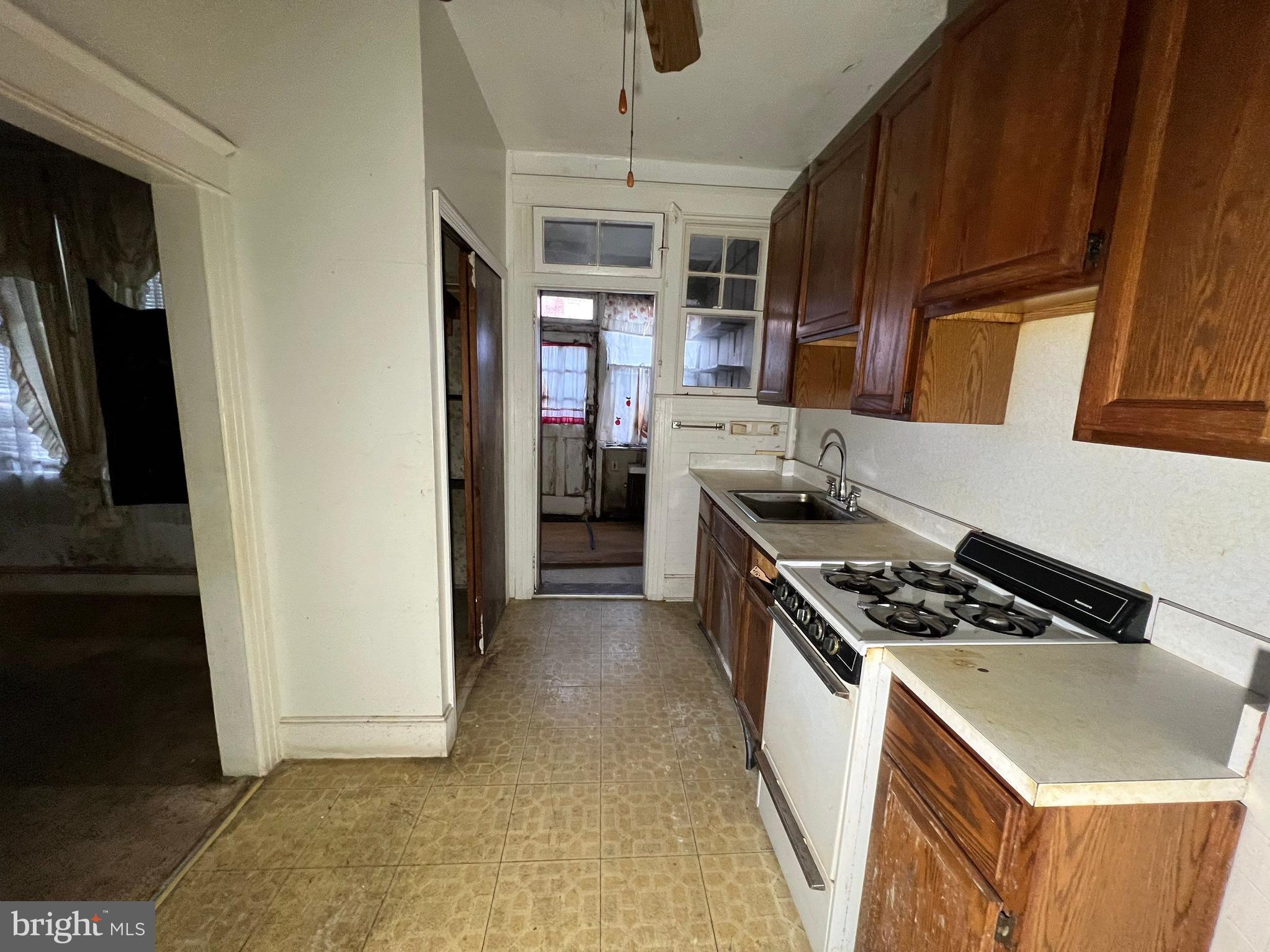 3421 St Ambrose Avenue Baltimore, MD 21215 - Photo 17 of 64 a kitchen with stainless steel appliances granite countertop a stove a sink and a refrigerator