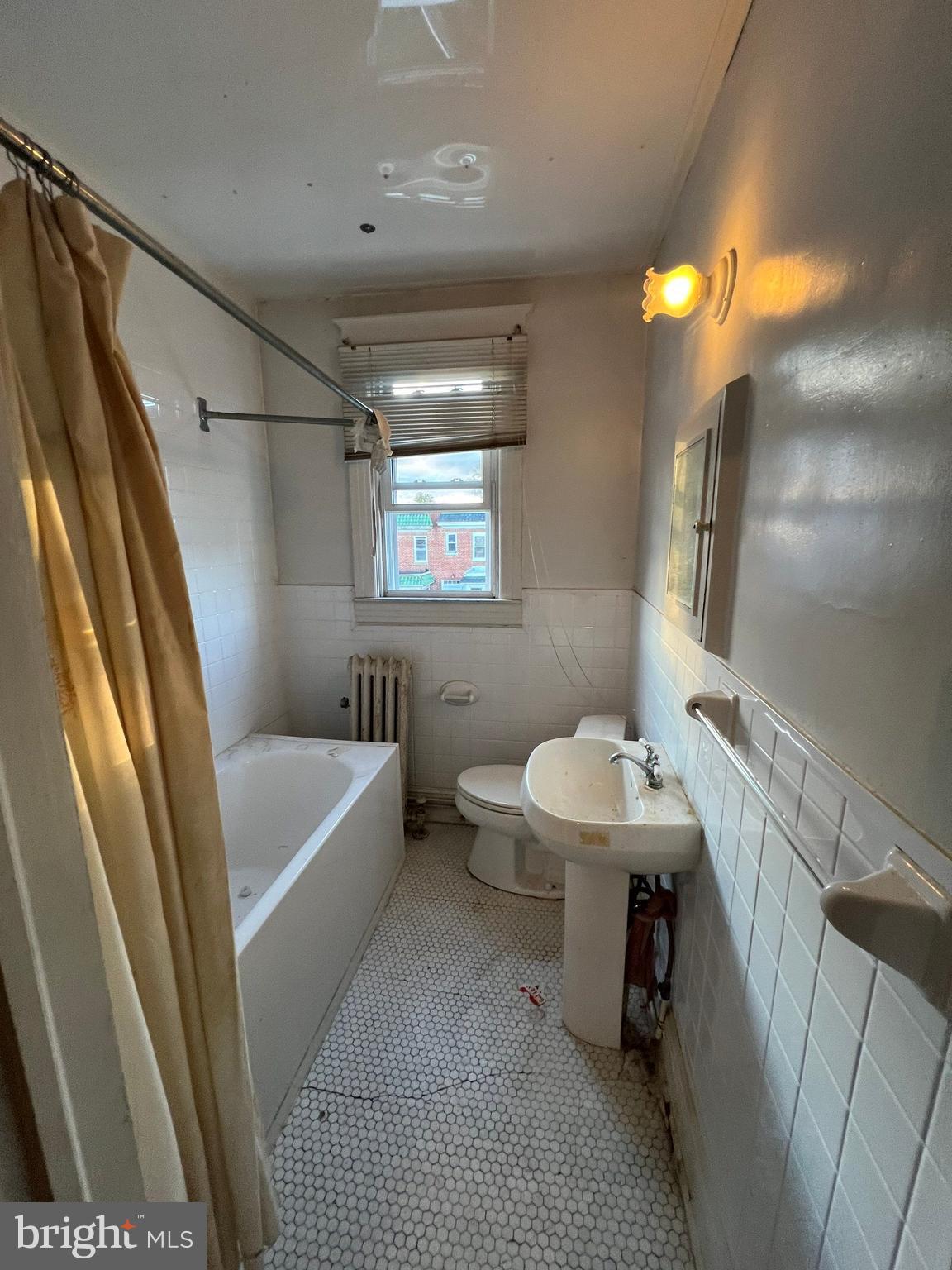3421 St Ambrose Avenue Baltimore, MD 21215 - Photo 25 of 64 a bathroom with a sink a toilet a tub and shower