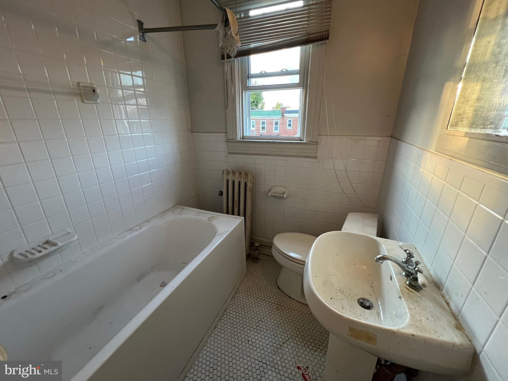 3421 St Ambrose Avenue Baltimore, MD 21215 - Photo 26 of 64 a bathroom with a sink a toilet and shower
