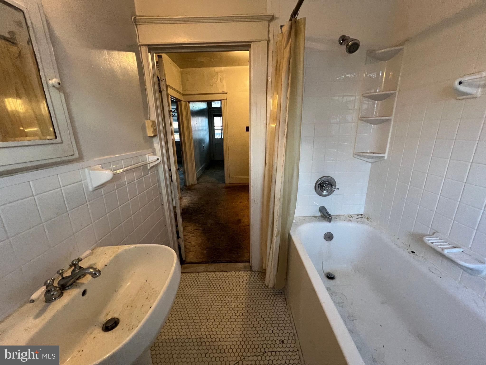 3421 St Ambrose Avenue Baltimore, MD 21215 - Photo 27 of 64 a bathroom with a tub a sink and mirror
