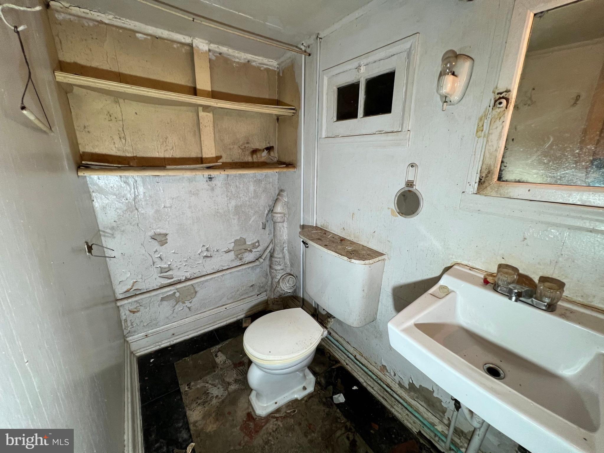 3421 St Ambrose Avenue Baltimore, MD 21215 - Photo 46 of 64 a white toilet sitting next to a bathroom sink