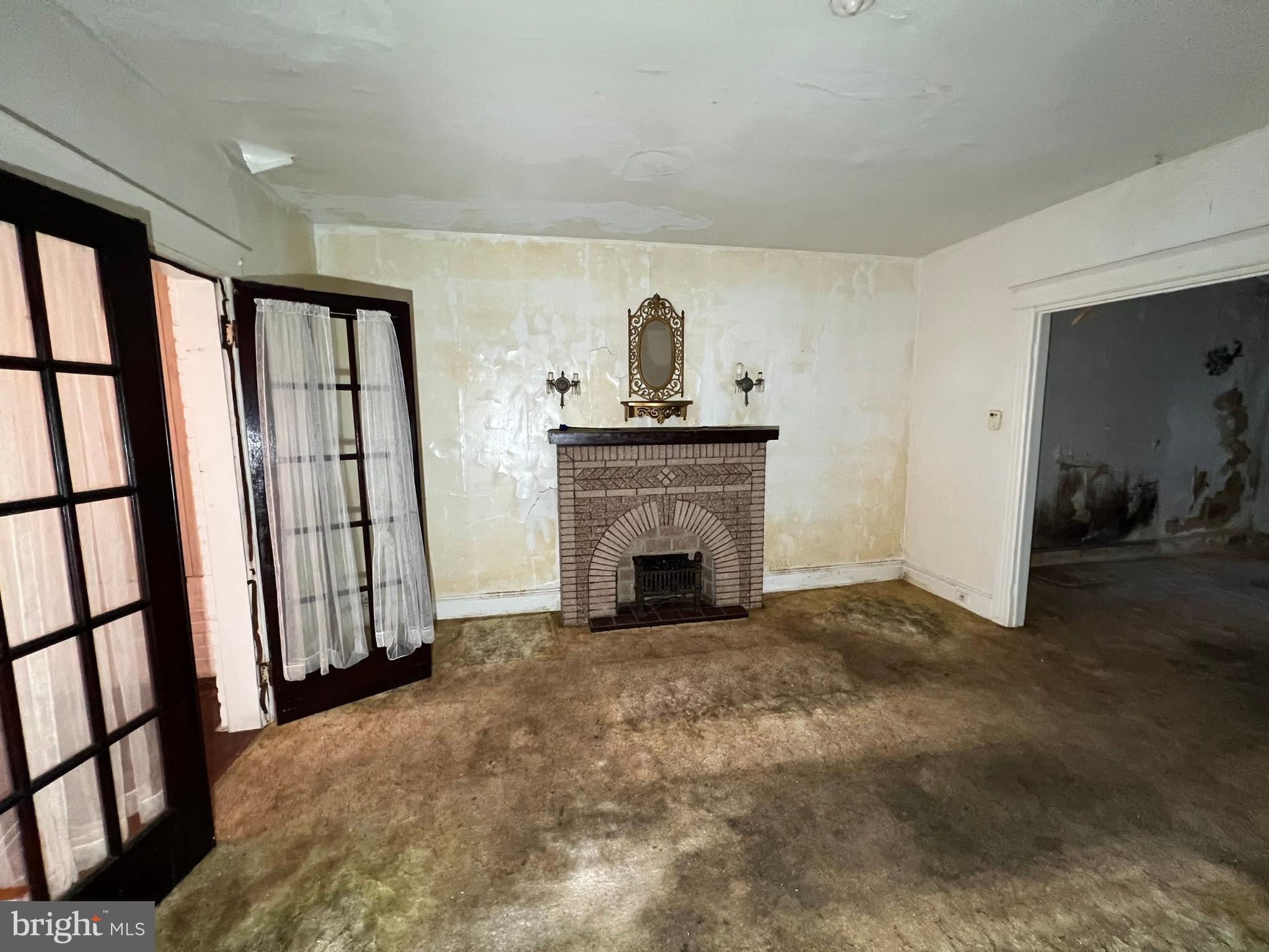 3421 St Ambrose Avenue Baltimore, MD 21215 - Photo 7 of 64 a view of empty room with fireplace and wooden floor