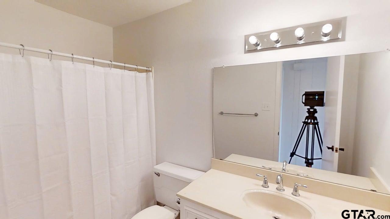 17035 Deer Run Road Flint, TX 75762 - Photo 15 of 31 a bathroom with a sink and a mirror