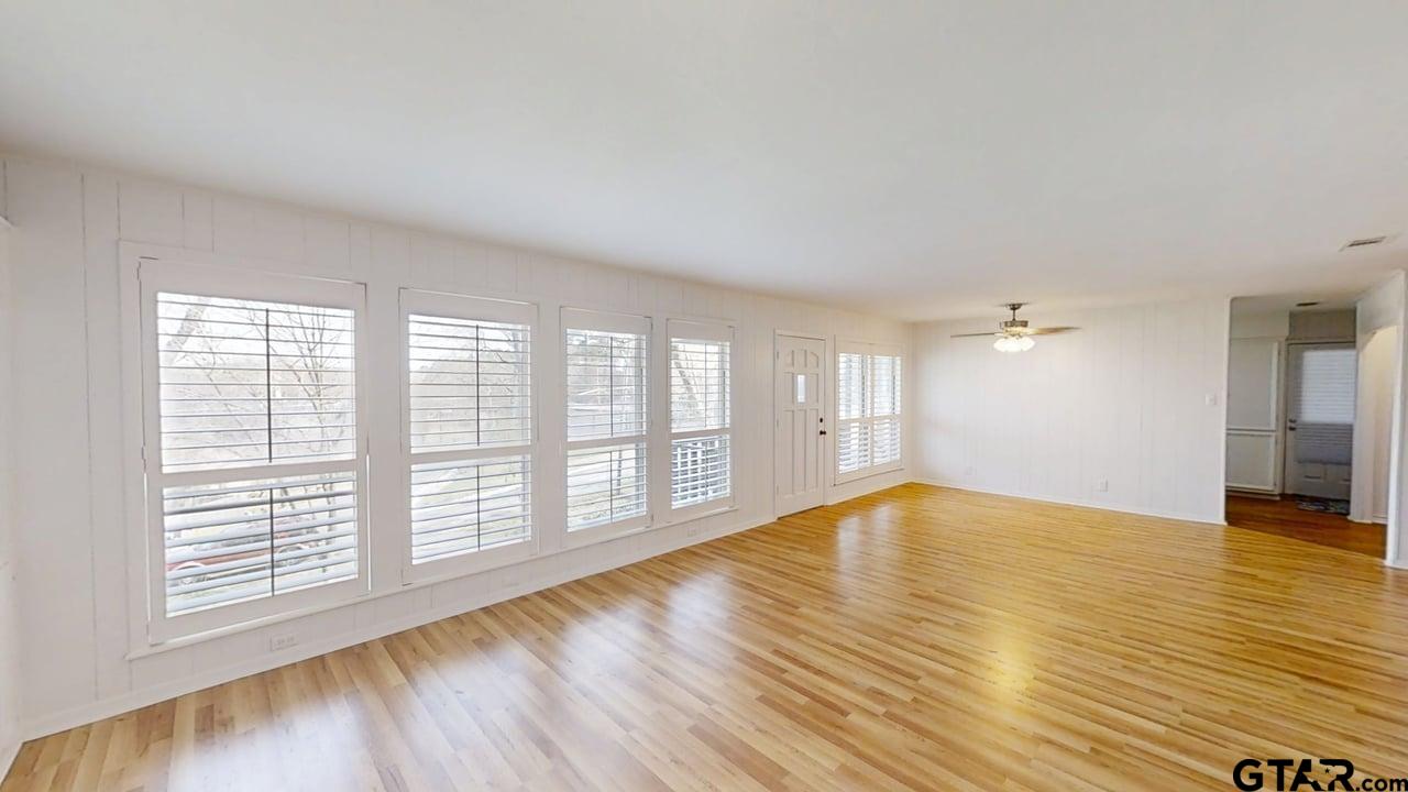 17035 Deer Run Road Flint, TX 75762 - Photo 4 of 31 a view of an empty room with wooden floor and a window