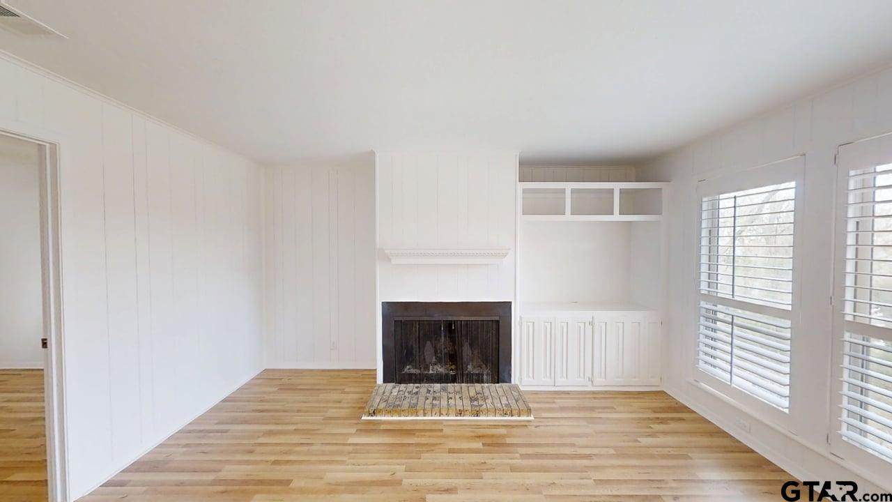 17035 Deer Run Road Flint, TX 75762 - Photo 5 of 31 a view of an empty room with wooden floor and a window