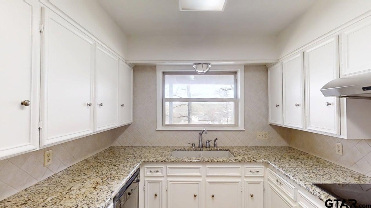 17035 Deer Run Road Flint, TX 75762 - Photo 8 of 31 a bathroom with granite countertop granite countertop white cabinets and a sink