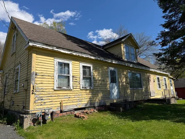 a front view of a house with a yard