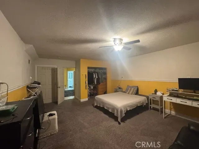 a bed room with a bed and a chair