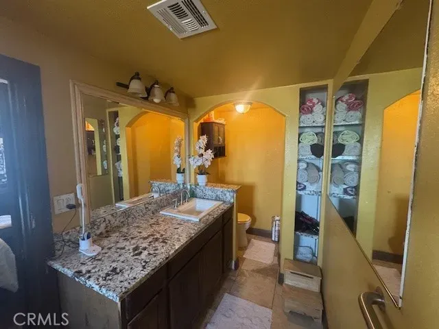 a view of a big room with furniture floor to ceiling windows and a clock
