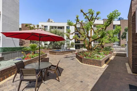 a view of a patio with furniture and a garden