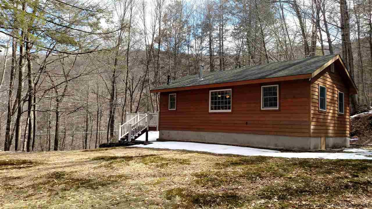 a view of a house with snow on the road