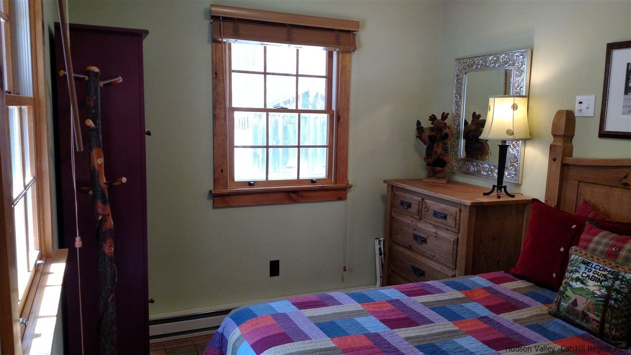 148 Pantherkill Road Phoenicia, NY 12464 - Photo 17 of 23 a bedroom with a bed and a dresser