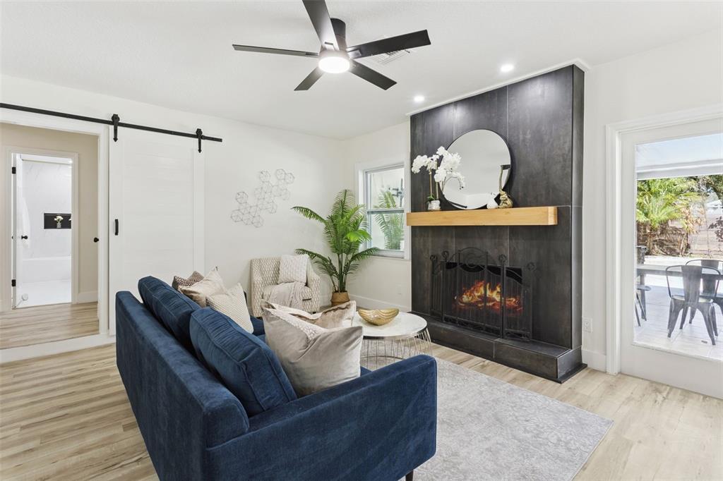 407 Forest Road Mount Dora, FL 32757 - Photo 12 of 35 a living room with furniture and a fireplace