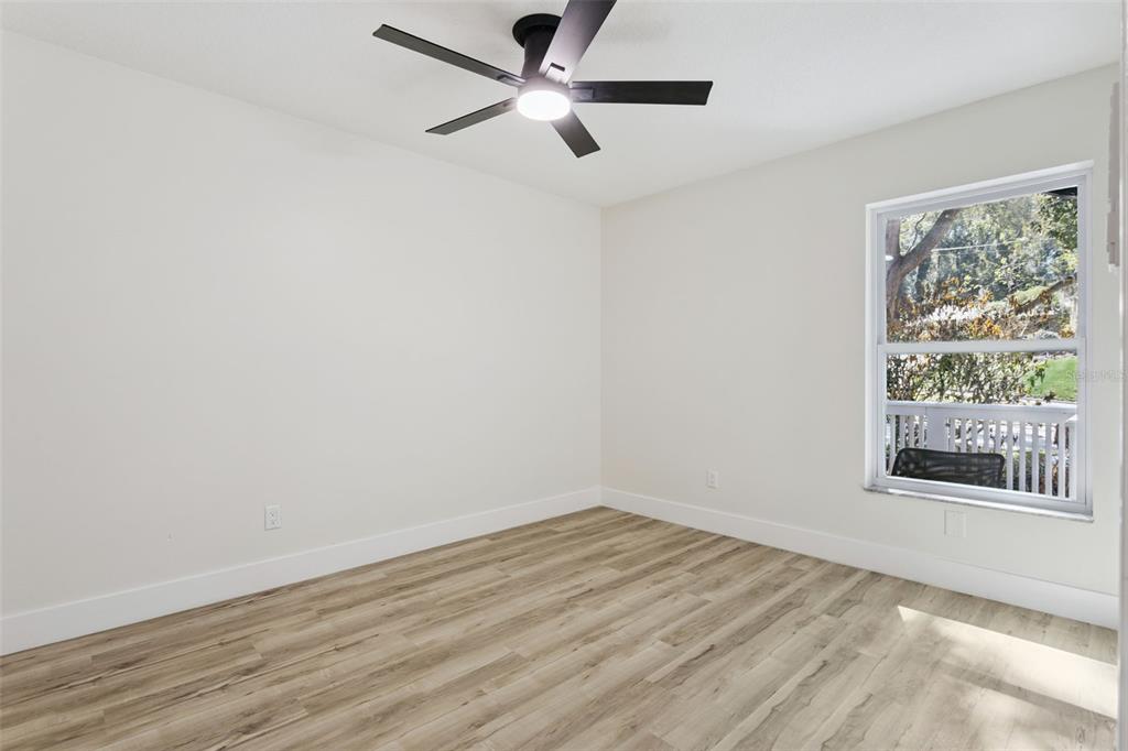 407 Forest Road Mount Dora, FL 32757 - Photo 17 of 35 wooden floor in an empty room with a window