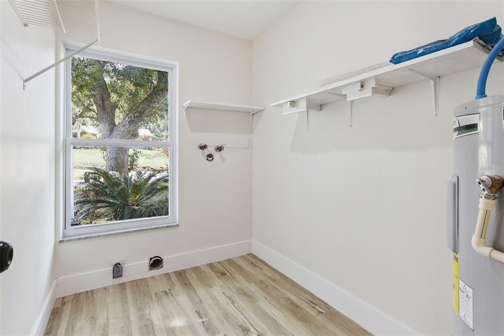 407 Forest Road Mount Dora, FL 32757 - Photo 20 of 35 a view of a small space with wooden floor and a window