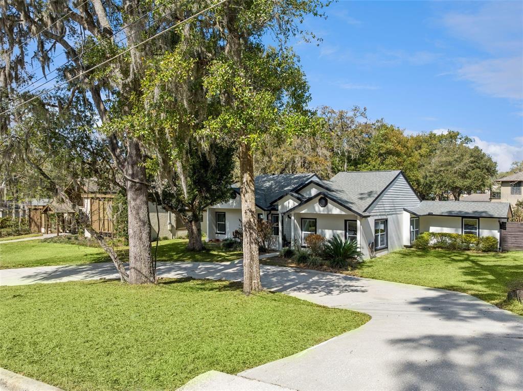 407 Forest Road Mount Dora, FL 32757 - Photo 2 of 35 a front view of a house with a yard