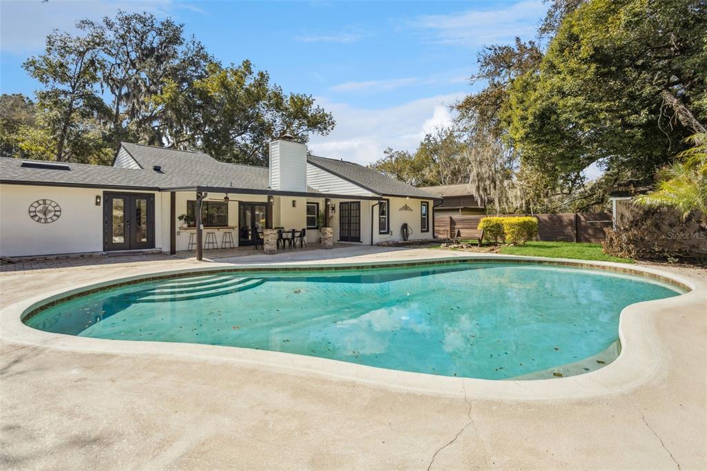 407 Forest Road Mount Dora, FL 32757 - Photo 24 of 35 front view of a house with a swimming pool