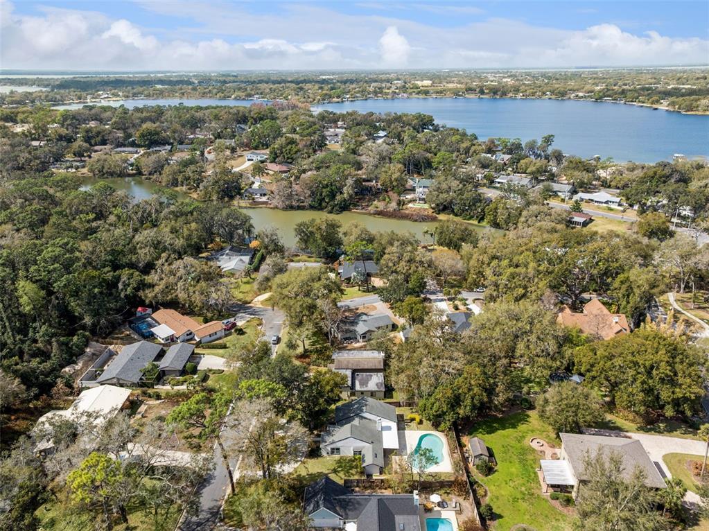 407 Forest Road Mount Dora, FL 32757 - Photo 31 of 35 an aerial view of a city with lots of residential buildings
