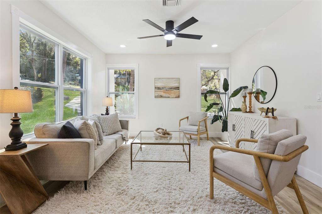 407 Forest Road Mount Dora, FL 32757 - Photo 5 of 35 a living room with furniture and a large window