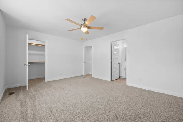 a bathroom with a toilet a sink a mirror a bathtub and vanity