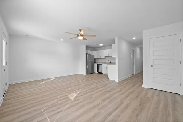 a view of a kitchen with a sink and a refrigerator