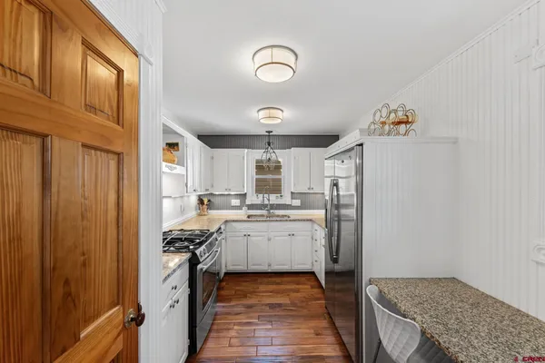 a kitchen with refrigerator and cabinets