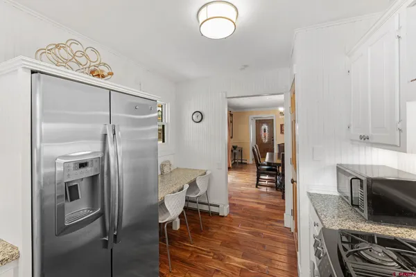 a kitchen with stainless steel appliances granite countertop a refrigerator and a stove top oven