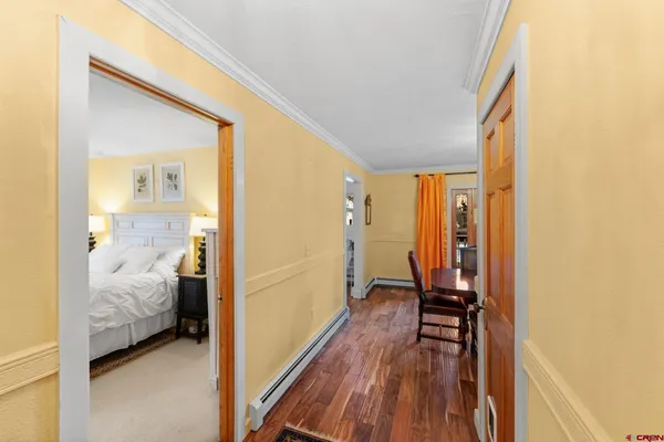 a view of a bedroom with bed and wooden floor