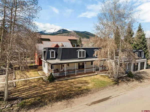 a view of a house with a large window and a yard