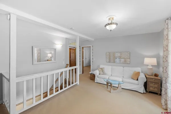 a living room with furniture and a chandelier