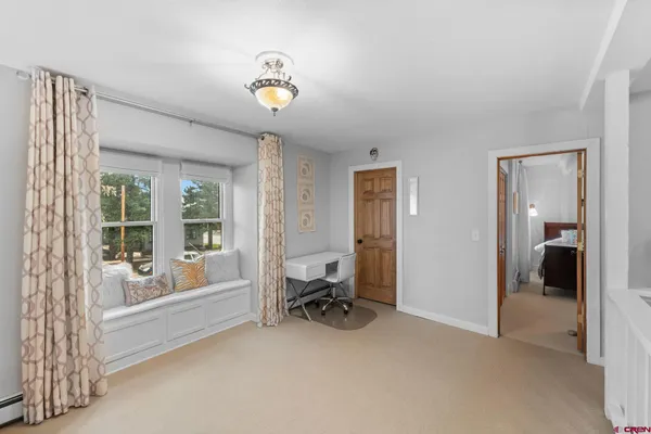 a view of a room with a window and chair