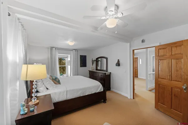 a spacious bedroom with a bed and a chandelier