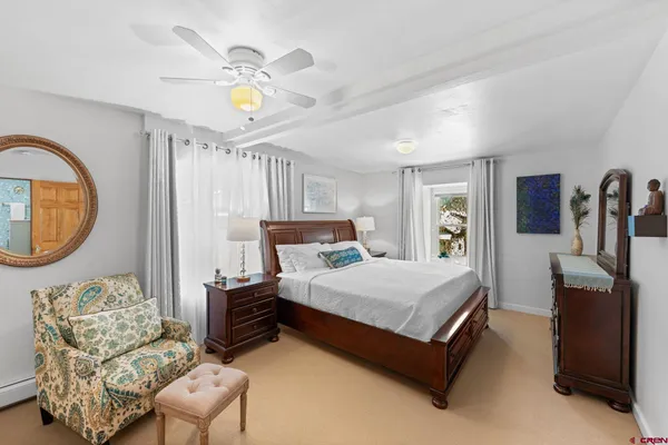 a bedroom with bed and a chandelier