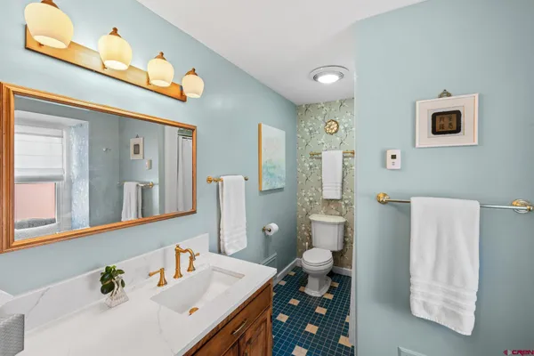 a bathroom with a sink vanity and a mirror