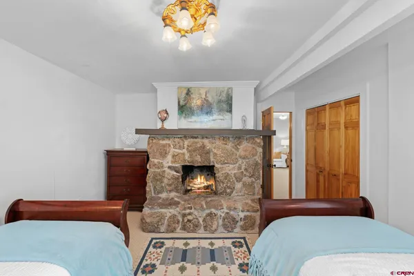 a bedroom with a bed and a fireplace