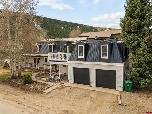 a view of a house with wooden fence