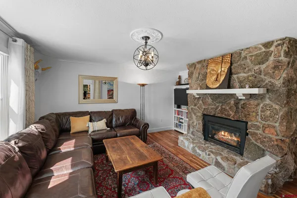 a living room with furniture a clock and a fireplace
