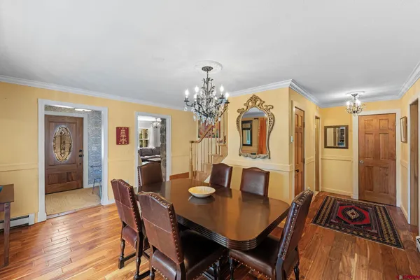 a view of a dining room with furniture and chandelier