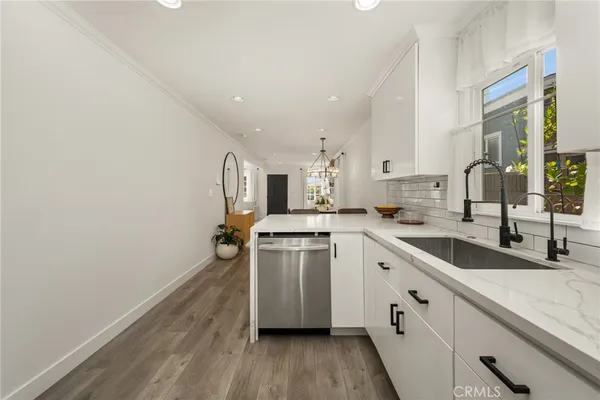 a bathroom with a granite countertop sink and a toilet